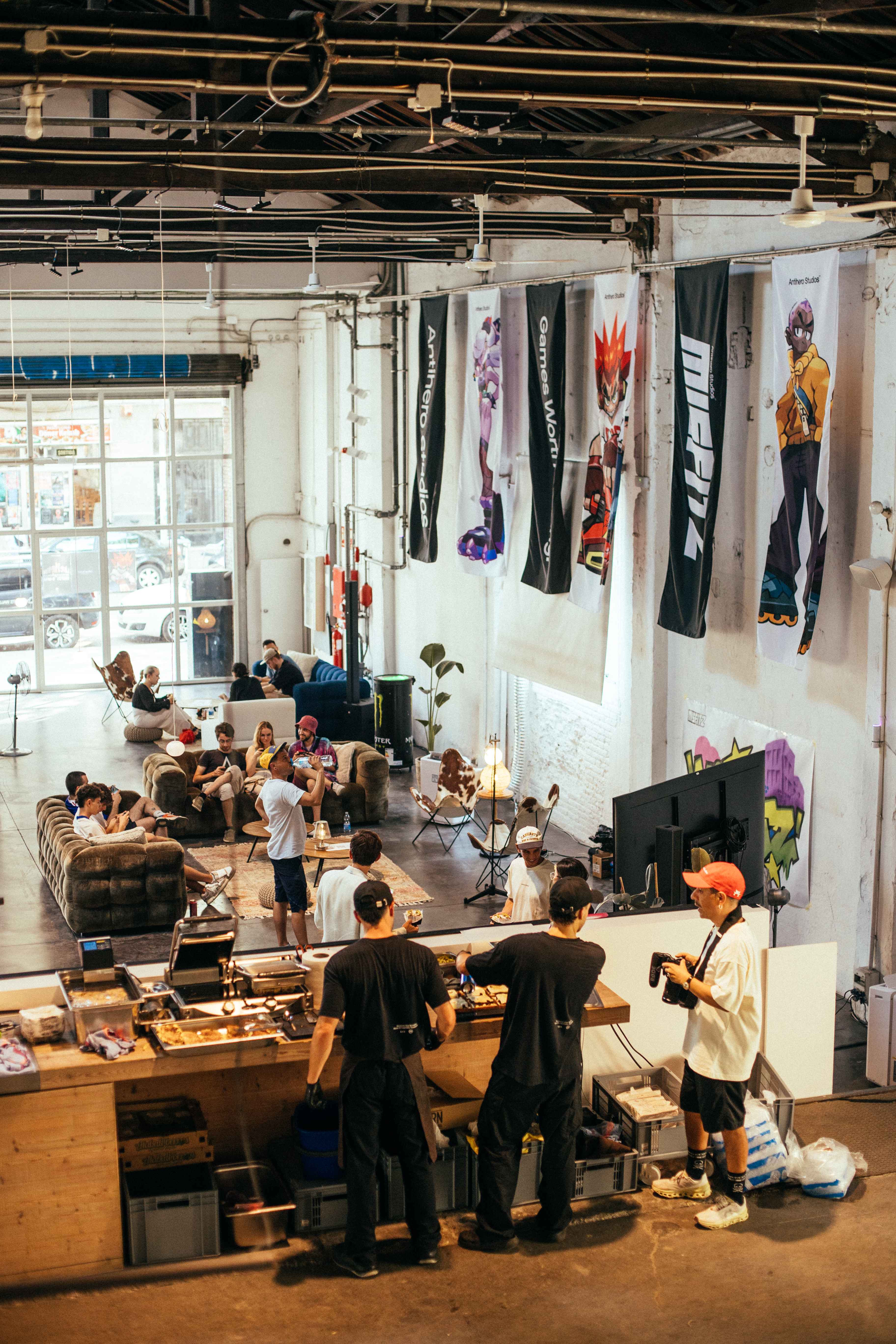 An overhead view of the busy event space with many attendees.